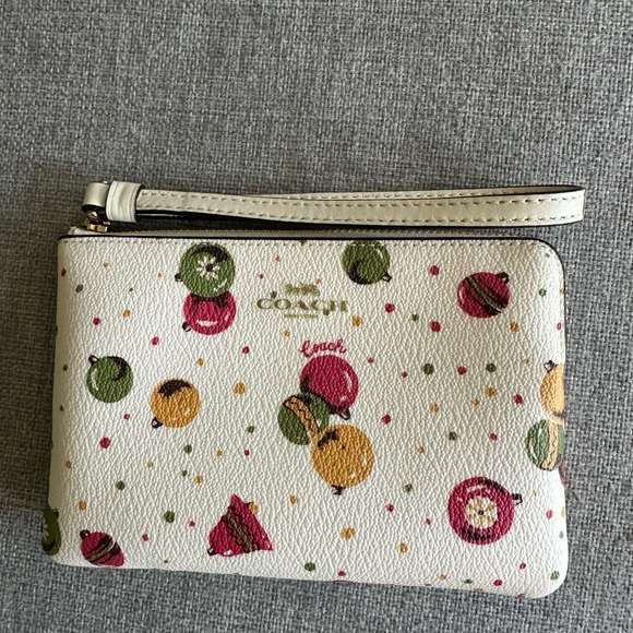 Coach Handbags - Coach Cream Wristlet with Christmas Ornament Print